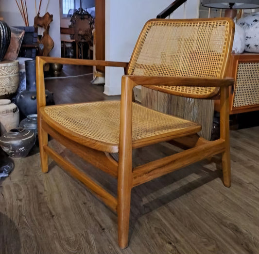Rattan armchair with velvet cushion in boho style